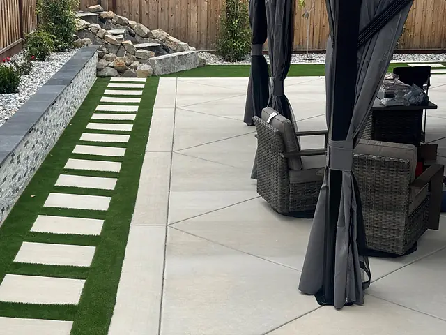 Hardtop gazebo with curtains and lounge seating on a concrete patio